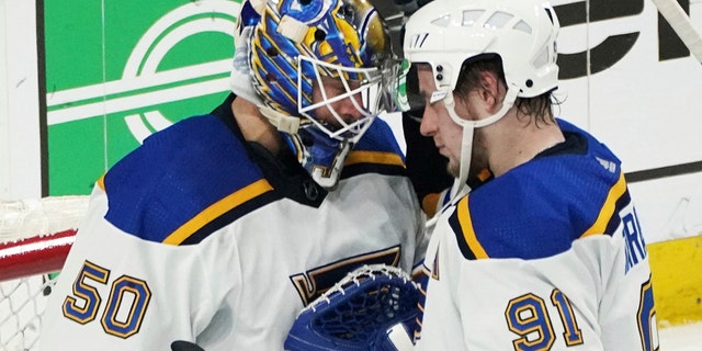 St. Louis Blues goalie Jordan Binnington (50) and St. Louis Blues' Vladimir Tarasenko celebrate the Blues' 5-2 win over the Minnesota Wild in Game 5 of an NHL hockey Stanley Cup first-round playoff series, Tuesday, May 10, 2022, in St. Paul, Minn. Tarasenko scored three goals Lin the game. 