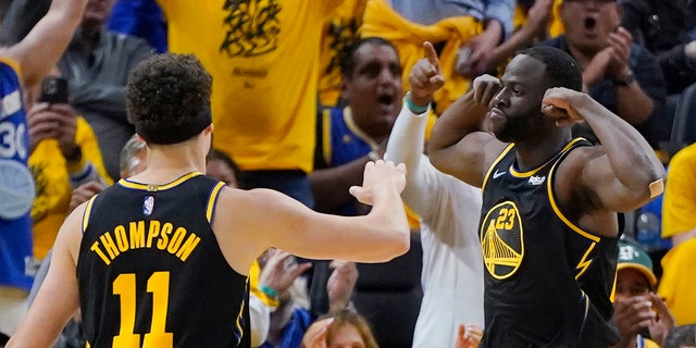 Golden State Warriors forward Draymond Green (23) celebrates next to guard Klay Thompson (11) during the first half in Game 5 of the team's NBA basketball playoffs Western Conference finals against the Dallas Mavericks in San Francisco, Thursday, May 26, 2022. (AP Photo/Jeff Chiu)