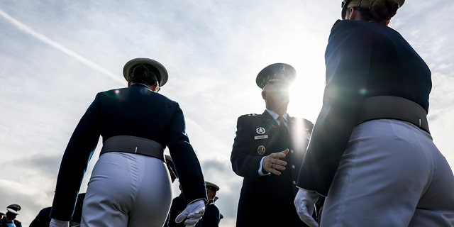 United States Space Force Chief of Space Operations Gen. John W. "Jay" Raymond (R) greets United States Air Force Academy graduates before their graduation at Falcon Stadium on May 26, 2021 in Colorado Springs, Colorado. 