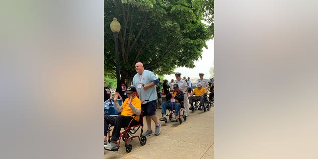 Veterans are assisted during a trip, courtesy of Honor Flight Network, to Washington, D.C., to visit and experience the memorials recognizing and respecting their service and sacrifice.