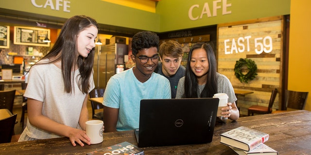 Teens gather around a laptop while enjoying beverages from the Hoover Library cafe, in Hoover, Alabama. (Hoover Library/Lance Shores)