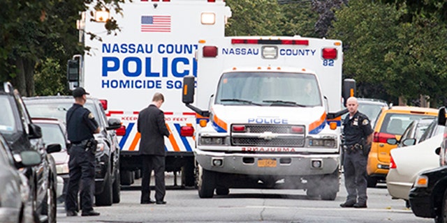 Nassau and Hempstead police investigate the scene of a triple homicide in Hempstead, New York. 