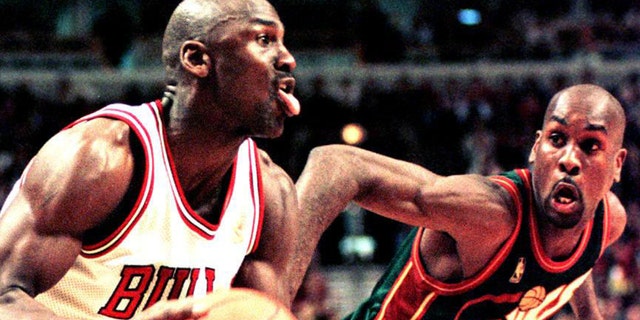 Michael Jordan of the Chicago Bulls looks to make a basket as Seattle SuperSonics guard Gary Payton defends in the fourth quarter of the 18 March game at the United Center in Chicago, Illinois.
