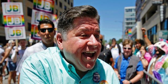 Illinois Gov. JB Pritzker greets spectators during the Chicago Pride Parade in Chicago, Sunday, June 26, 2022.