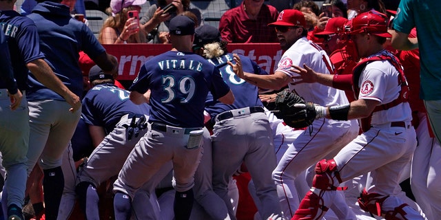 Several members of the Seattle Mariners and the Los Angeles Angels scuffle after Mariners' Jesse Winker was hit by a pitch during the second inning of a baseball game Sunday, June 26, 2022, in Anaheim, Calif. 