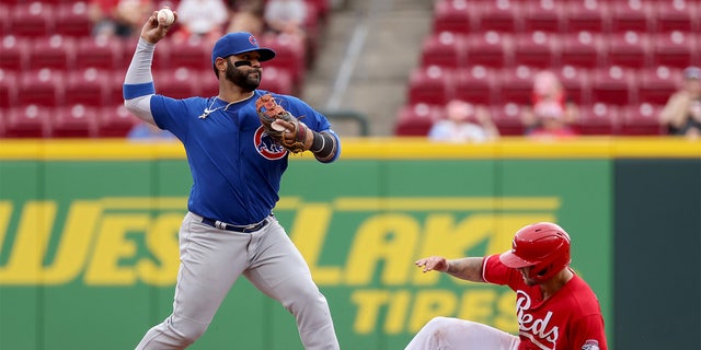 CINCINNATI, OHIO - MAY 26: Jonathan Villar #24 of the Chicago Cubs attempts to turn a double play past Nick Senzel #15 of the Cincinnati Reds in the seventh inning at Great American Ball Park on May 26, 2022 in Cincinnati, Ohio.
