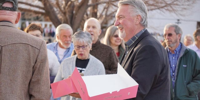 Republican Senate candidate Joe O'Dea of Colorado hands out donuts to voters outside the state GOP assembly, on April 9, 2022, in Colorado Springs, Colorado