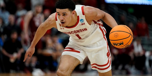 Wisconsin's Johnny Davis dribbles during the first-round NCAA college basketball tournament game against Colgate on March 18, 2022, in Milwaukee.