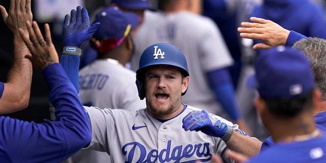 Los Angeles Dodgers' Max Muncy celebrates his three-run home run off Chicago White Sox relief pitcher Bennett Sousa during the sixth inning of a baseball game Thursday, June 9, 2022, in Chicago.