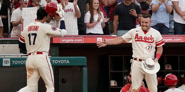 Los Angeles Angels' Mike Trout, right, extends his hand to Shohei Ohtani to celebrate Ohtani's home run during the third inning of the team's baseball game against the Chicago White Sox on Tuesday, June 28, 2022, in Anaheim, Calif. 