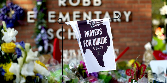 A banner hangs at a memorial outside Robb Elementary School, the site of a recent Texas school shooting that has energized gun control activists in the media. 