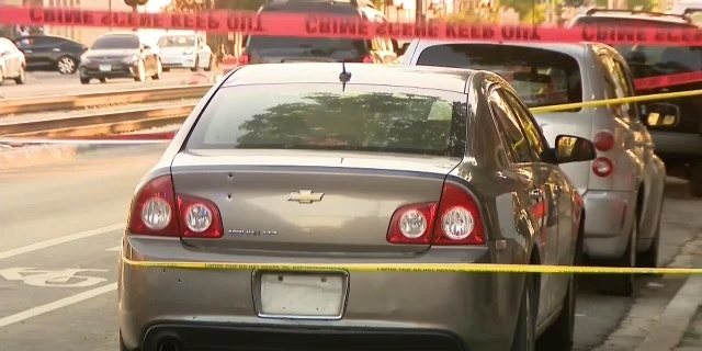 The cordoned off crime scene where bullets entered a car, striking a 5-month-old baby inside. 