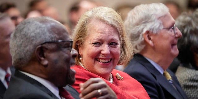 Supreme Court Justice Clarence Thomas sits with his wife Virginia Thomas while he waits to speak at the Heritage Foundation on October 21, 2021 in Washington, D.C. 