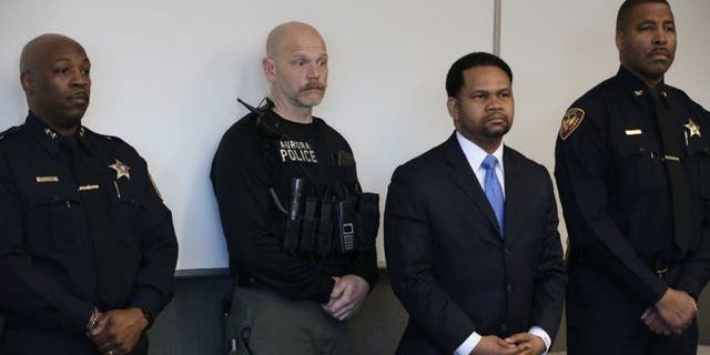 Aurora, Illinois, police officers and Aurora mayor Richard Irvin, second from right, during a news conference after a 2018 shooting incident in the city. 