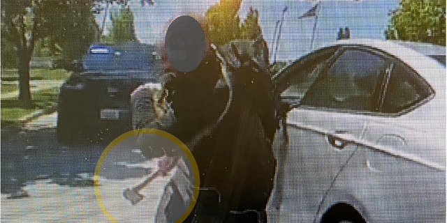 This still from body-worn camera footage shows a man wielding a hatchet charging at a police officer in the Chicago suburb of Naperville, Illinois. 