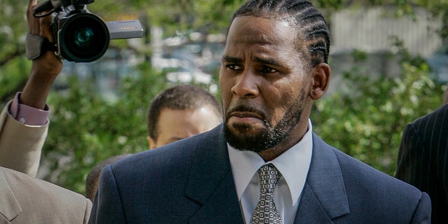 This photo from Friday May 9, 2008, shows R. Kelly arriving for the first day of jury selection in his child pornography trial at the Cook County Criminal Courthouse in Chicago. 