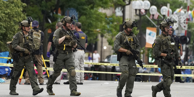 Law enforcement search after a mass shooting at the Highland Park Fourth of July parade in downtown Highland Park, Ill., a suburb of Chicago, on Monday, July 4.