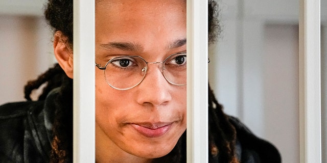 WNBA star and two-time Olympic gold medalist Brittney Griner speaks to her lawyers standing in a cage at a courtroom prior to a hearing, in Khimki just outside Moscow, Russia, July 26, 2022. 