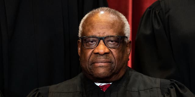 Associate Justice Clarence Thomas sits during a group photo of the justices at the Supreme Court in Washington, D.C., April 23, 2021. 