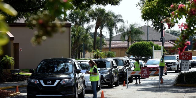 Cars line up in June 2022 to enter a food distribution event sponsored by the Second Harvest Food Bank of Central Florida and Orange County at St. John Vianney Church in Orlando, Florida. High food and gas prices are squeezing working families, sending some to food pantries for the first time; providers are struggling with inflation costs as demand spikes. 