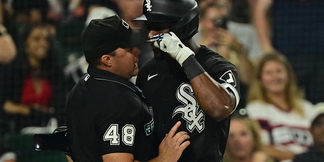 Tim Anderson of the Chicago White Sox, right, is tossed from a game after apparent contact with umpire Nick Mahrley (48) in the seventh inning against the Oakland Athletics at Guaranteed Rate Field July 29, 2022, in Chicago.