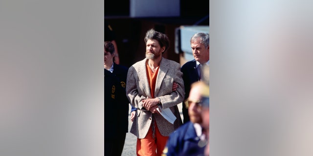 Police officers bring Ted Kaczynski, aka the Unabomber, to court for arraignment, April 4, 1996. Kaczynski later pled guilty to the mail bomb attacks that killed three people and injured 23.