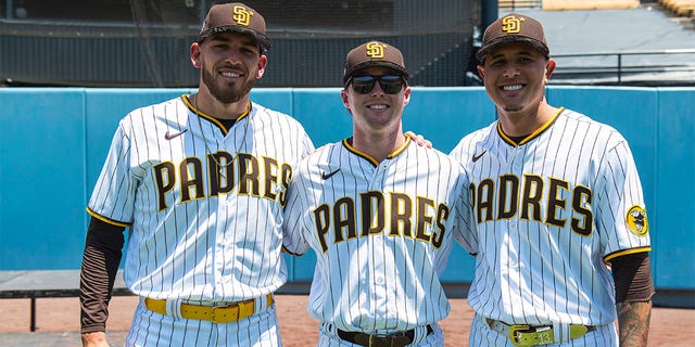 Joe Musgrove #44, Jake Cronenworth #9 and Manny Machado #13 of the San Diego Padres pose for a photo during the 2022 Gatorade All-Star Workout Day at Dodger Stadium on July 18, 2022 in Los Angeles, California. 