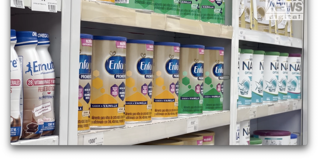 Baby formula cans are shown on shelves at a pharmacy in Tijuana, Mexico. 