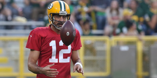 Green Bay Packers quarterback Aaron Rodgers (12) flips a ball during Green Bay Packers Family Night at Lambeau Field, on Aug. 5, 2022 in Green Bay, WI.