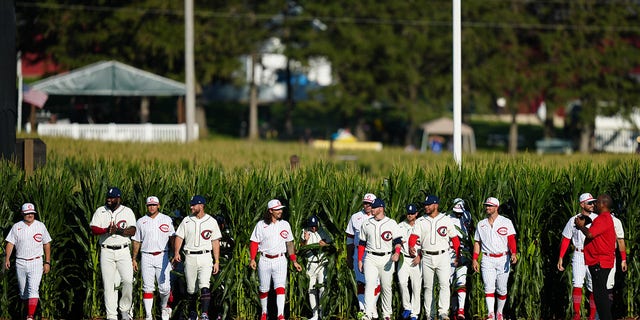 The Cincinnati Reds and Chicago Cubs emerge from the cornfield before the game between the Chicago Cubs and the Cincinnati Reds at The MLB Field at Field of Dreams on Thursday, August 11, 2022 in Dyersville, Iowa.