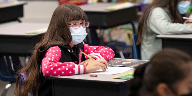 A student listens to her teacher in a second and third grade class at Robert M. Pyles STEM Academy in Stanton, Calif., Jan. 13, 2022. 