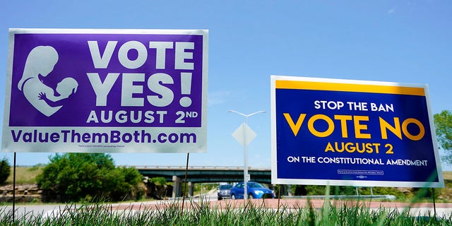 Signs in favor and against the Kansas Constitutional Amendment On Abortion are displayed outside Kansas 10 Highway on Aug. 1, 2022, in Lenexa, Kansas.