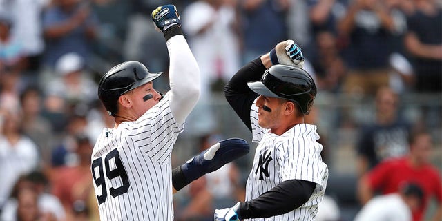 New York Yankees' Aaron Judge (99) celebrates with Anthony Rizzo, right, after Rizzo's home run against the Kansas City Royals during the seventh inning of a baseball game Sunday, July 31, 2022, in New York. 