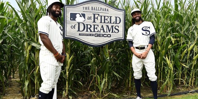Brian Goodwin, #18, (L) and Billy Hamilton, #0 of the Chicago White Sox, pose for a photo while walking through the Field of Dreams movie site prior to the game against the New York Yankees on August 12, 2021 at Field of Dreams in Dyersville, Iowa.