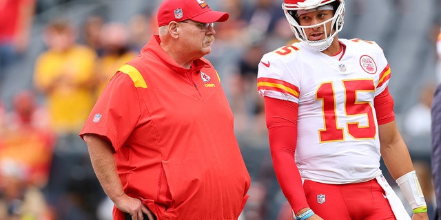 Head coach Andy Reid and Patrick Mahomes of the Kansas City Chiefs talk prior to a preseason game against the Bears at Soldier Field on Aug. 13, 2022, in Chicago.