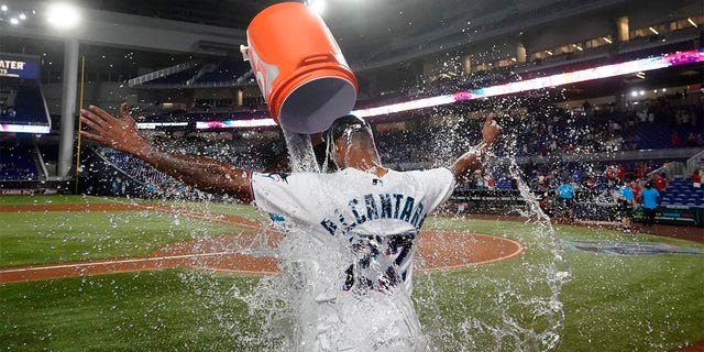 Miami Marlins starting pitcher Sandy Alcantara is doused by Pablo Lopez after the Marlins beat the Cincinnati Reds 3-0 in a baseball game, Wednesday, Aug. 3, 2022, in Miami. 