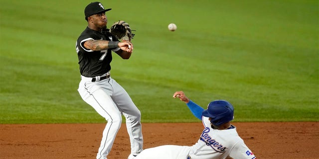 Chicago White Sox shortstop Tim Anderson throw to first to complete the double play after forcing Texas Rangers' Marcus Semien at second in the first inning of a baseball game, Thursday, Aug. 4, 2022, in Arlington, Texas. Corey Seager was out at first. 