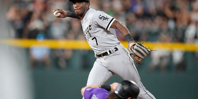 Chicago White Sox shortstop Tim Anderson, back, forces out Colorado Rockies' Brendan Rodgers at second base on the front end of a double play hit into by Ryan McMahon to end the sixth inning of a baseball game Tuesday, July 26, 2022, in Denver. 