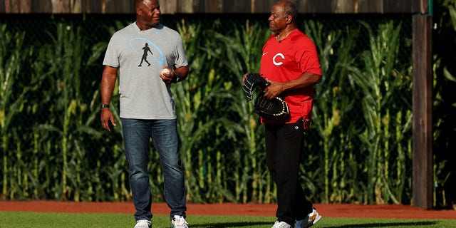 Former baseball player Ken Griffey Jr. (L) and his father Ken Griffey Sr. take the field before the game between the Chicago Cubs and the Cincinnati Reds at Field of Dreams on August 11, 2022 in Dyersville, Iowa.