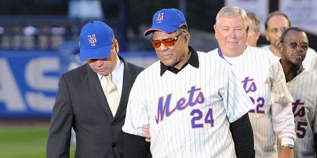 Former New York Mets players Willie Mays and Ray Knight walk onto the field after the game against the Florida Marlins to commemorate the last regular season baseball game ever played in Shea Stadium on September 28, 2008, in the Flushing neighborhood of the Queens borough of New York City.