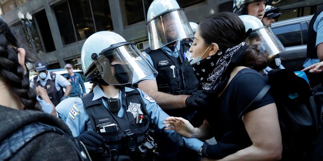 Chicago Police officers and protesters clash during a protest over the death of George Floyd in Chicago, Saturday, May 30, 2020. (AP Photo/Nam Y. Huh)
