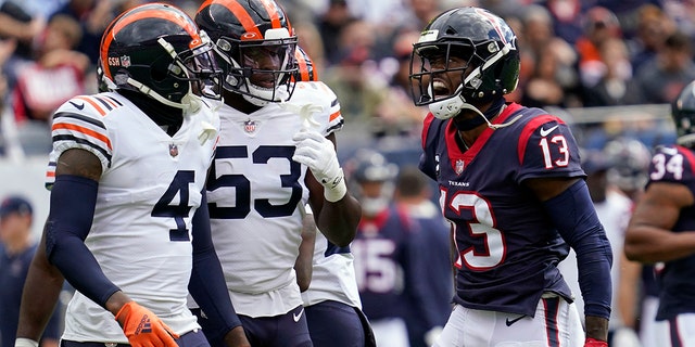Houston Texans wide receiver Brandin Cooks (13) yells toward Chicago Bears' Eddie Jackson (4) and Nicholas Morrow (53) during the first half of an NFL football game Sunday, Sept. 25, 2022, in Chicago.
