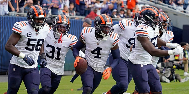 Chicago Bears safety Eddie Jackson (4) celebrates with teammates after intercepting a pass in the end zone against the Houston Texans during the first half of an NFL football game Sunday, Sept. 25, 2022, in Chicago. 