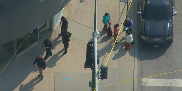 Investigators on the scene after an armed robbery outside an Apple store in Chicago.
