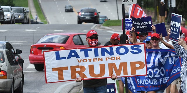 October 10, 2020 - Orlando, Florida, United States - People hold placards after U.S. Vice President Mike Pence addressed supporters at a Latinos for Trump campaign rally at Central Christian University on October 10, 2020, in Orlando, Florida. (Photo by Paul Hennessy/NurPhoto via Getty Images)