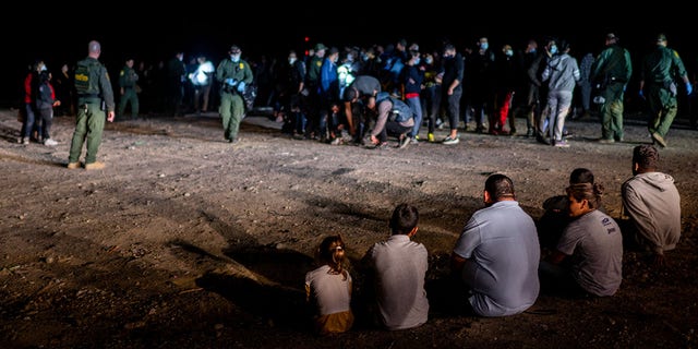 ROMA, TEXAS - MAY 05: A migrant family sits after being processed on May 05, 2022 in Roma, Texas. 