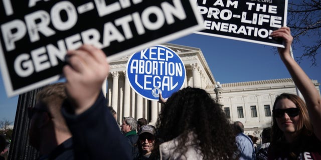 WASHINGTON, DC - JANUARY 19:  Pro-life activists try to block the sign of a pro-choice activist during the 2018 March for Life January 19, 2018 in Washington, DC. (Photo by Alex Wong/Getty Images)