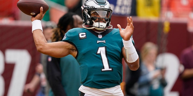 Philadelphia Eagles quarterback Jalen Hurts, #1, throws the ball before the start of an NFL football game against the Washington Commanders, Sunday, Sept. 25, 2022, in Landover, Maryland. 