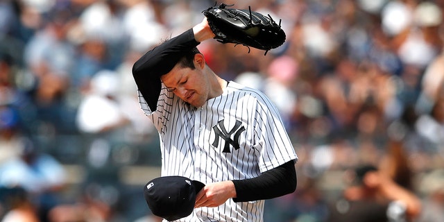 New York Yankees starting pitcher Jordan Montgomery pauses before pitching against the Kansas City Royals during the fifth inning July 31, 2022, in New York.