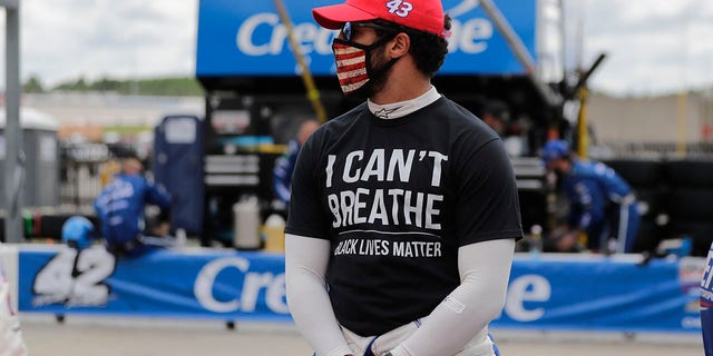 Bubba Wallace (43) wears a "I Can't Breath, Black Lives Matter" shirt before a NASCAR Cup Series auto race at Atlanta Motor Speedway, Sunday, June 7, 2020, in Hampton, Ga.